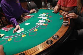 Multi-angle camera feed of live dealer shuffling and cutting deck before Caribbean Stud round